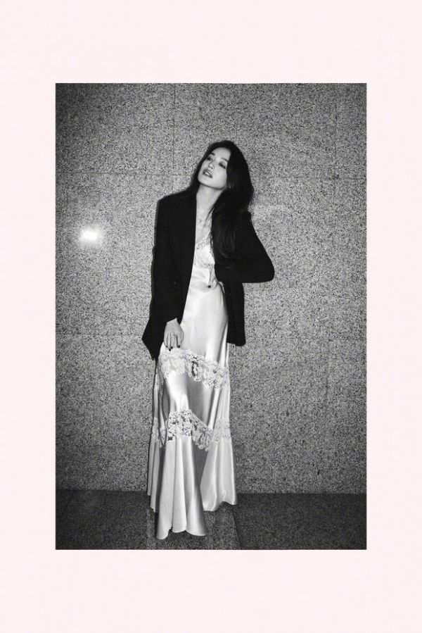 搜狐娱乐讯 近日，舒淇的一组美照曝出。图中，舒淇穿着西服外套搭配白色长裙，叉腰抬头，松弛感十足。