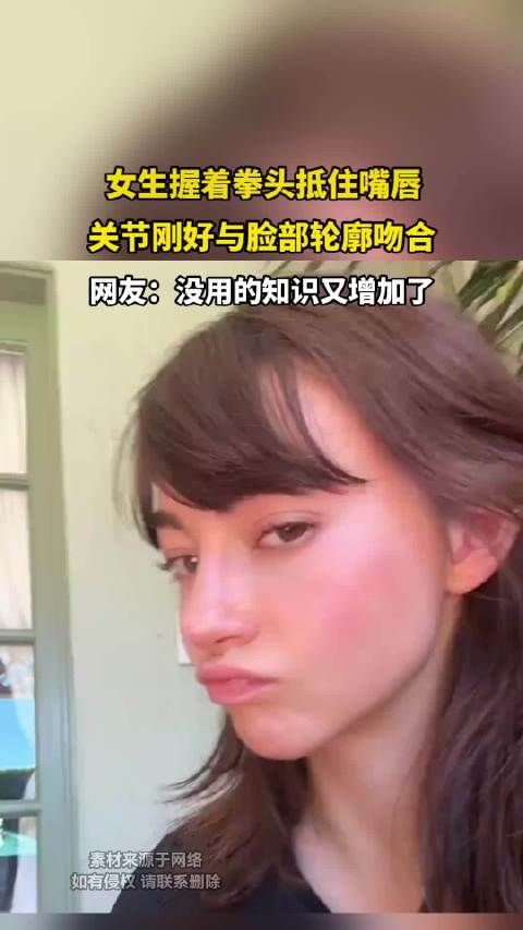 女生握着拳头抵住嘴唇,关节刚好与脸部轮廓吻合