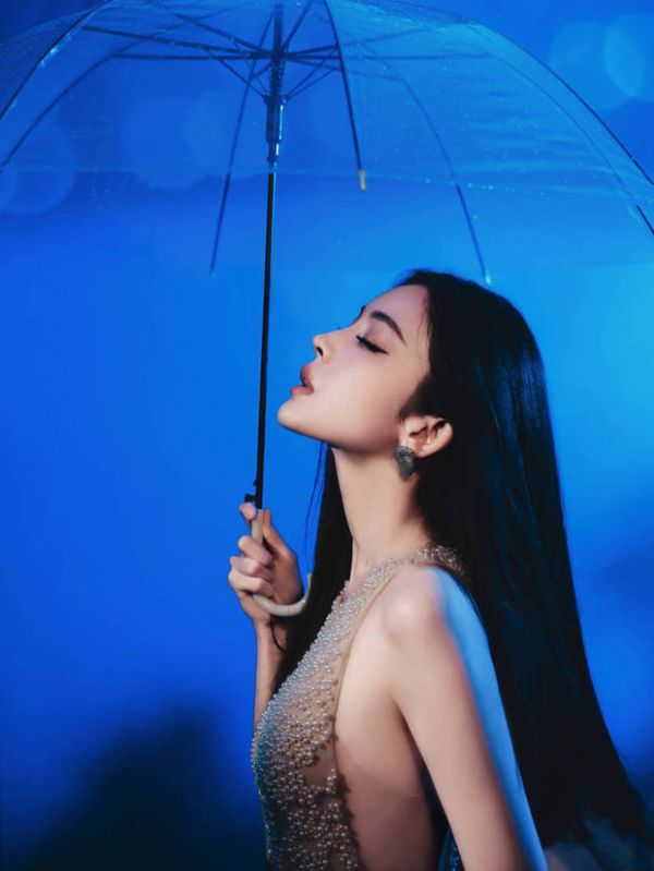 娜扎闭眼撑伞，颇具氛围感。