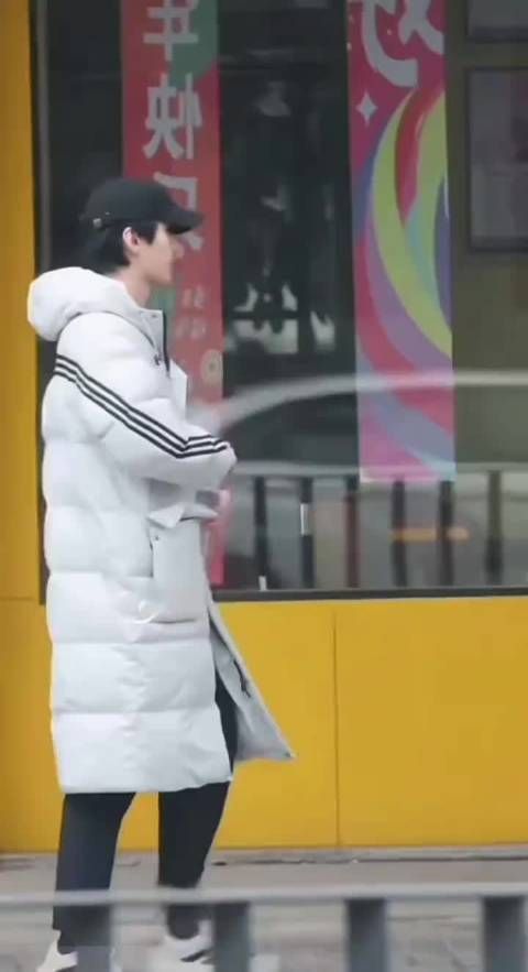 何与白色羽绒服戴帽子好青春男大 现在随时随地都有人在拍了会有点无奈吧